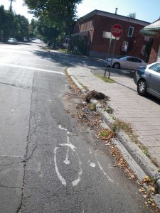 Chales AM Faded patched over too far right and obscured by debris This was among the first sharrows installed in Ottawa along Arlington