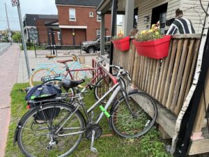 Three bikes parked by the patio of a local cafe