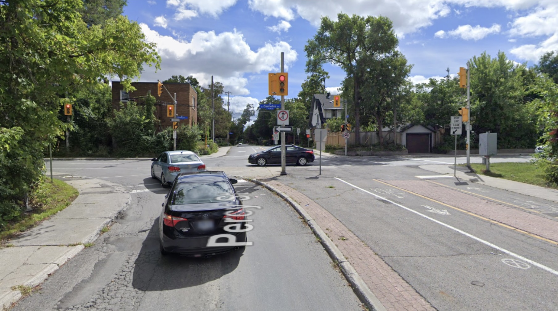 Google image of modal filtering with a car lane on the left and a multi use pathway on the right