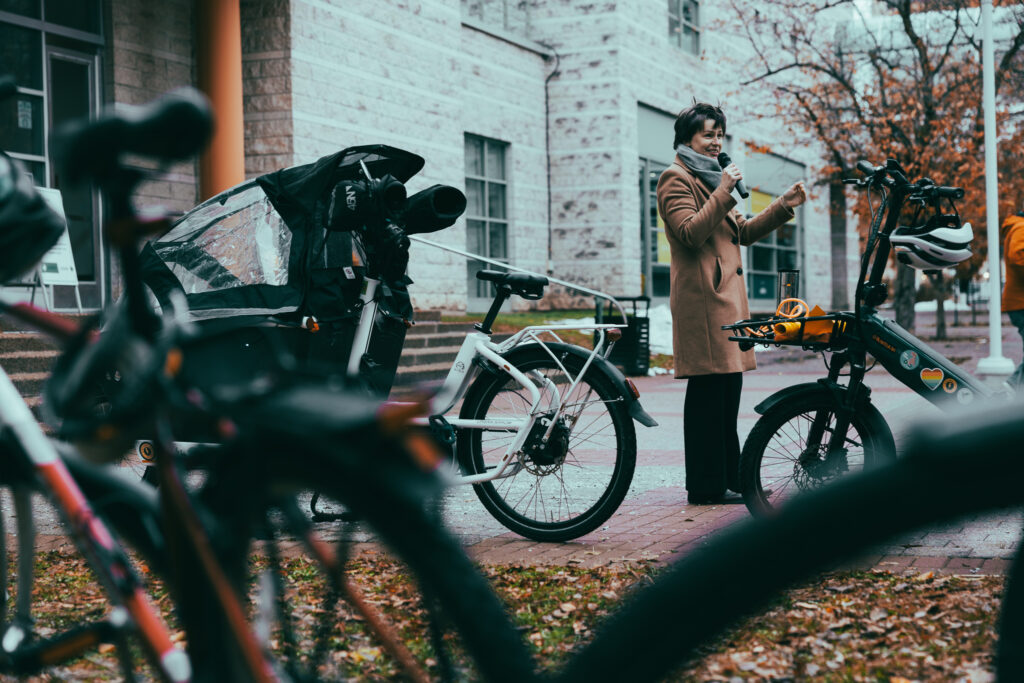 Christina Bouchard addressing the Bill 60 rally. She’s surrounded by bikes.