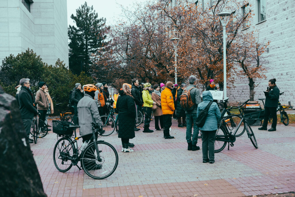 People and their bikes at the Bill 60 rally, as seen from the side. They’re listening to a speaker on the right.